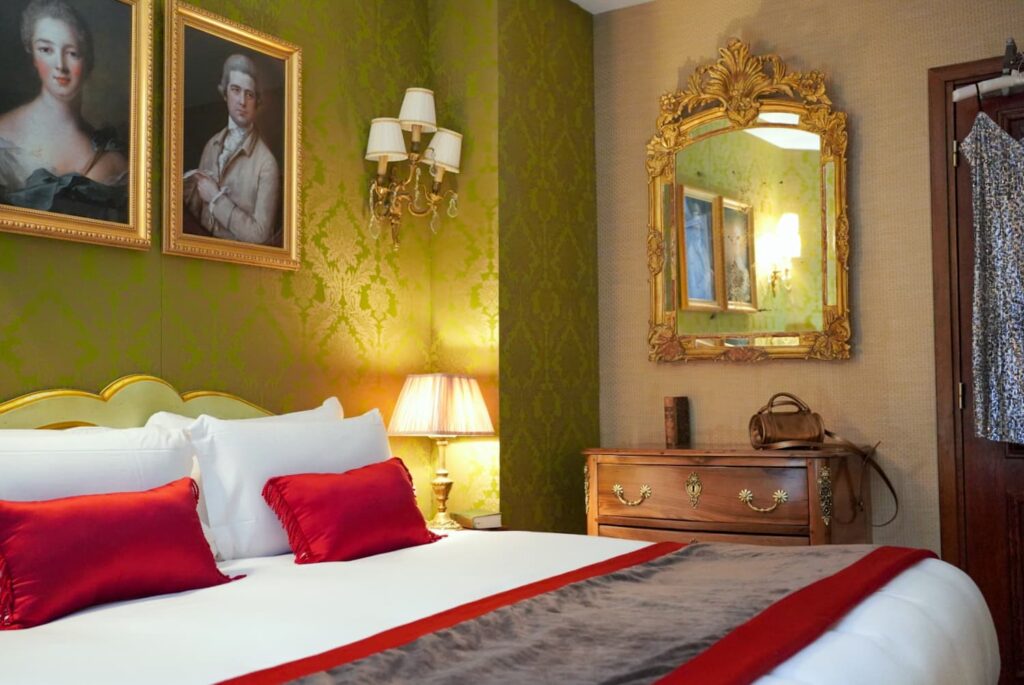 Christmas in Paris | room named la Pompadour room with green fabric, bed and red pillows | hotel de seine Paris